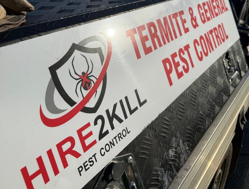 Hire2Kill logo and termite and general pest control signage on a work ute